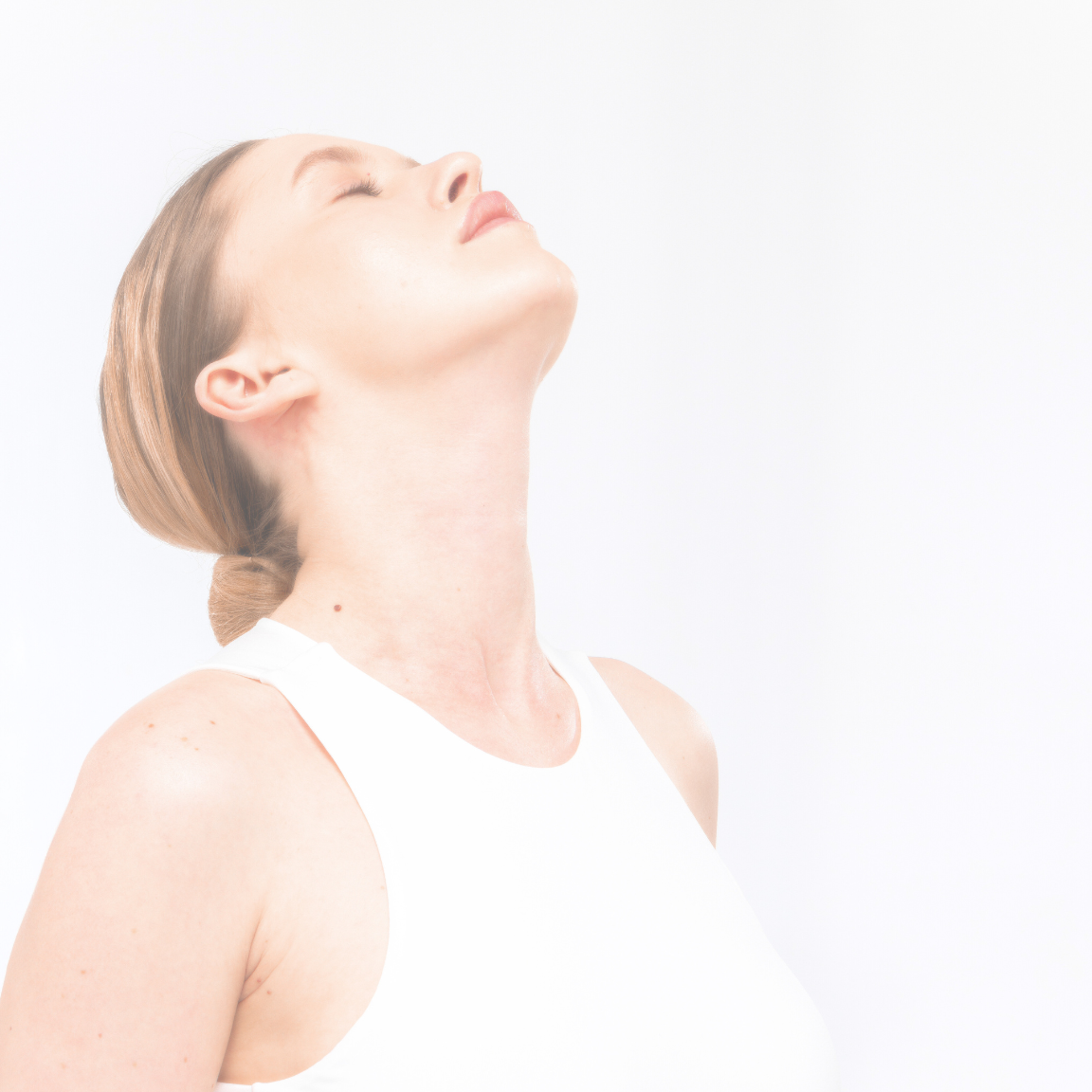 Woman with eyes closed and head tilted back on a light background.