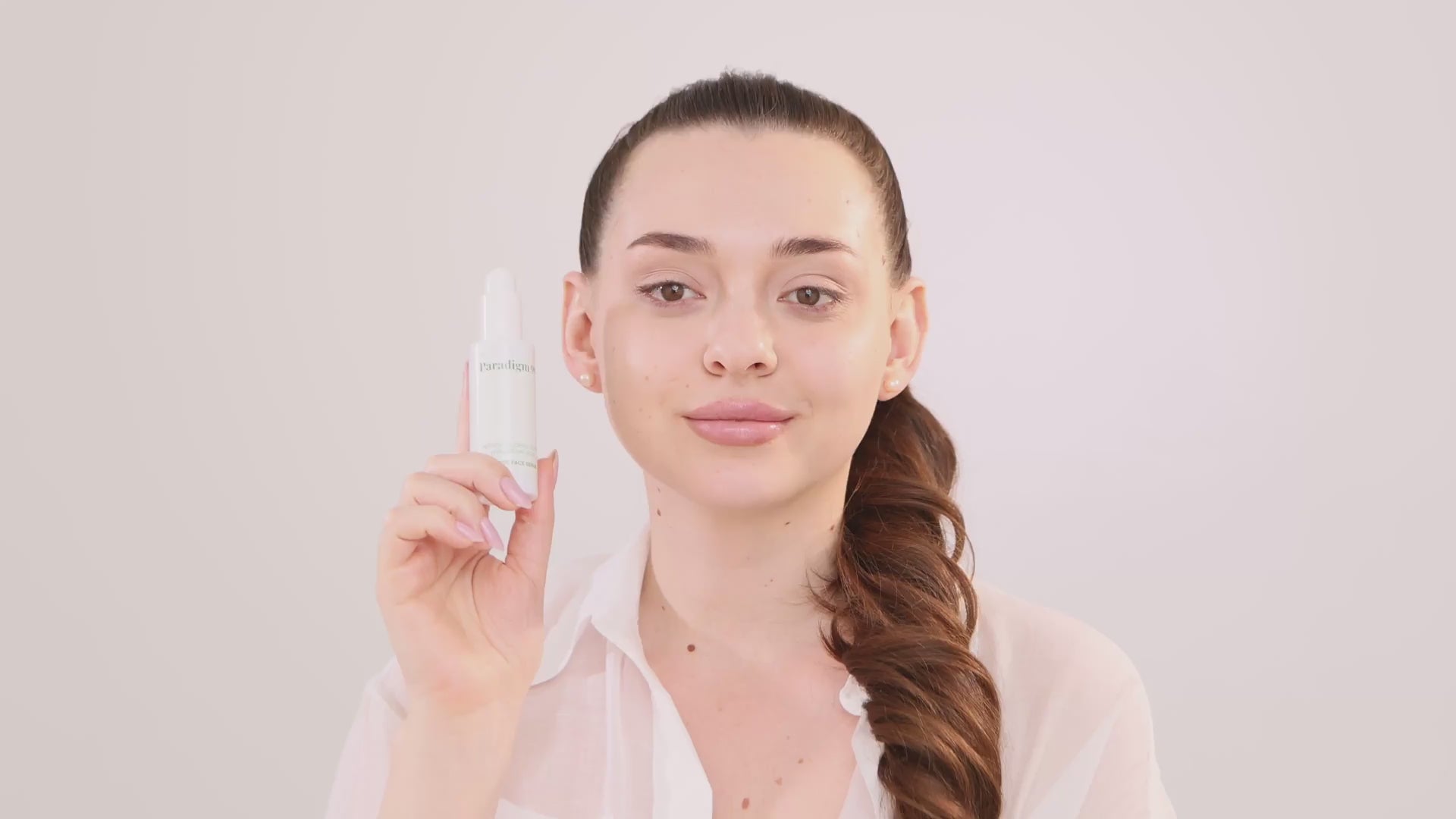 women apply peptide face serum with hyaluronic acid